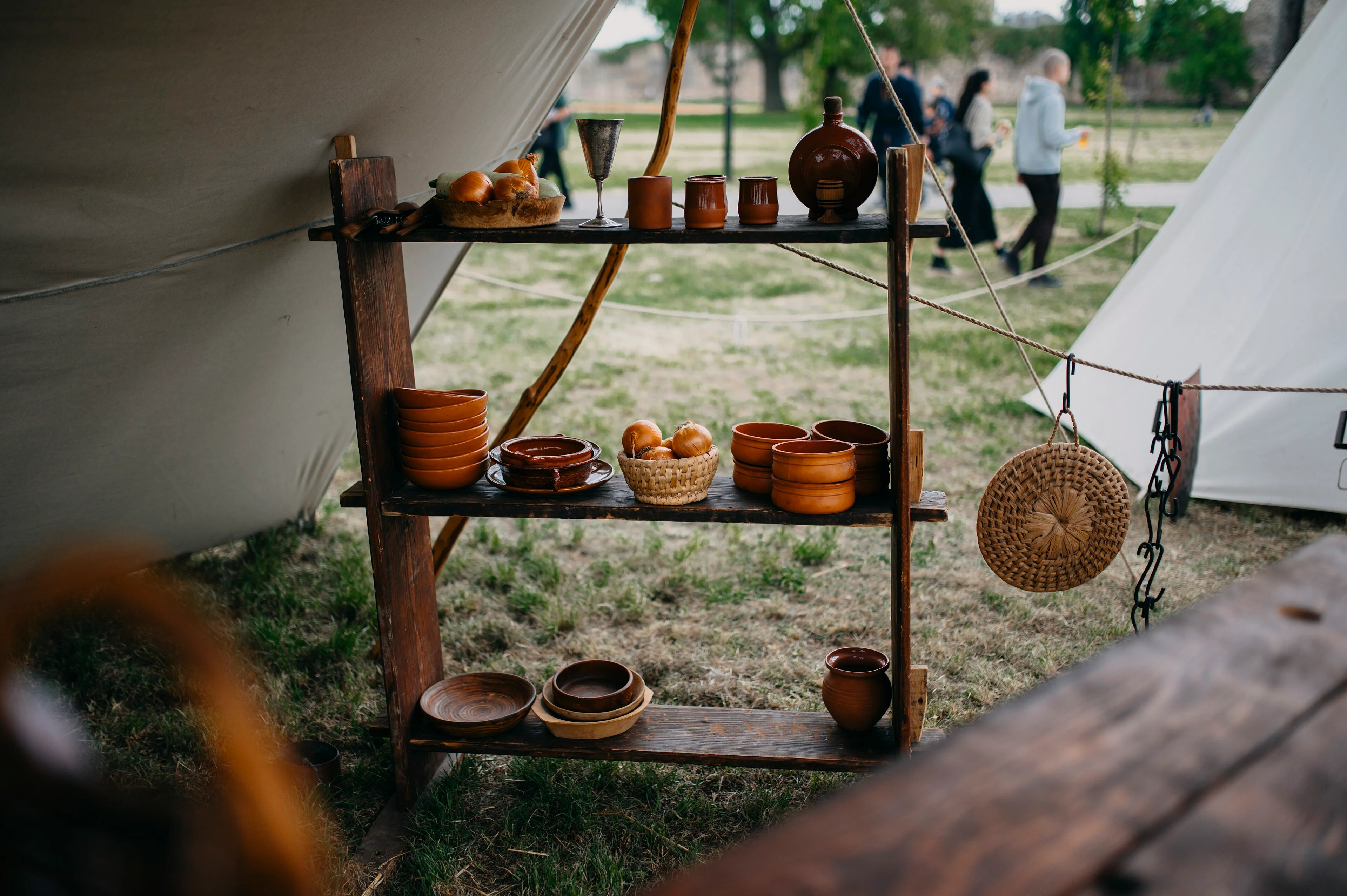 Handmade pottery and wooden objects arranged across a craft-market display.