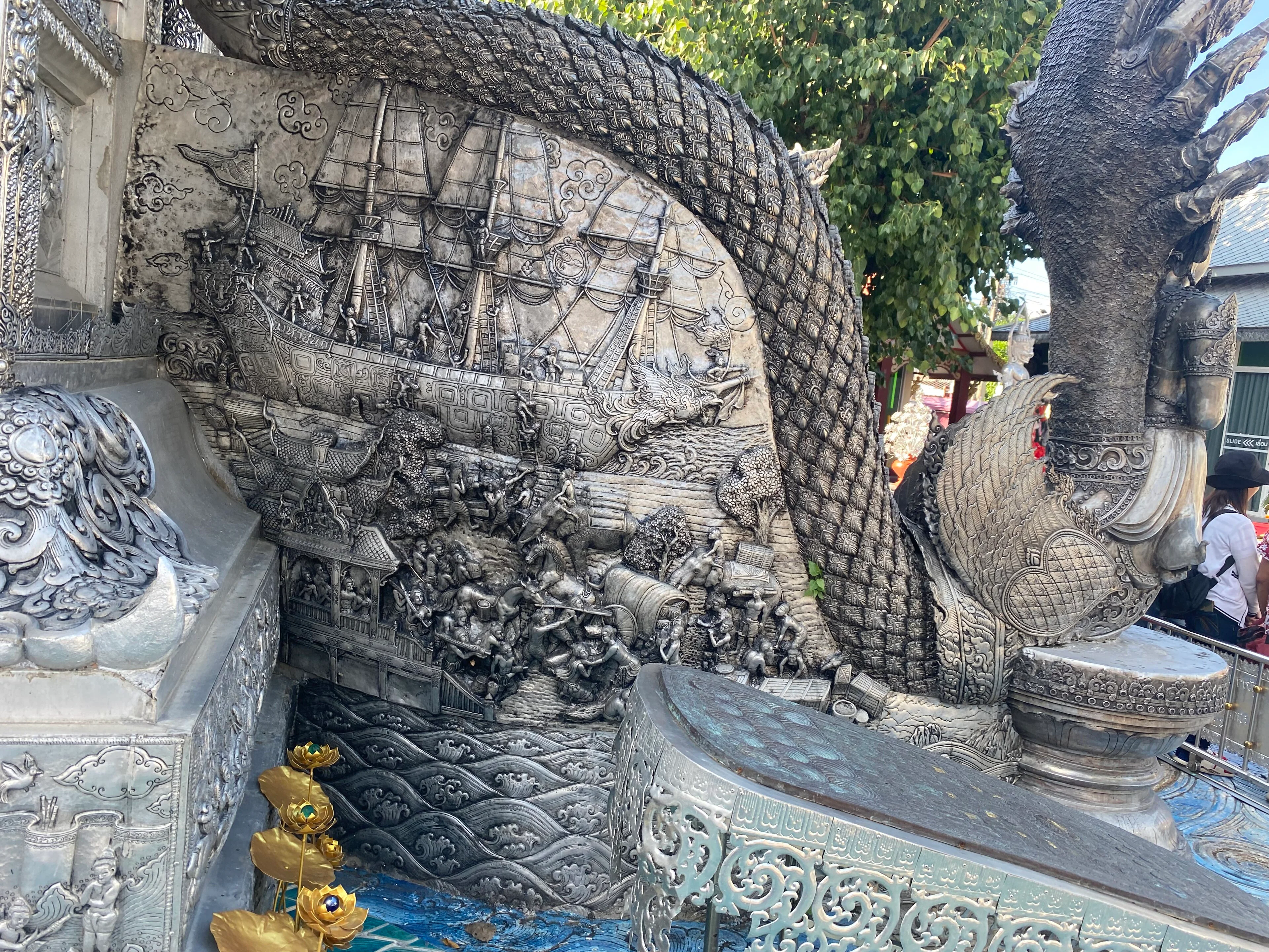 Detailed silver relief panels at Wat Sri Suphan in Chiang Mai.