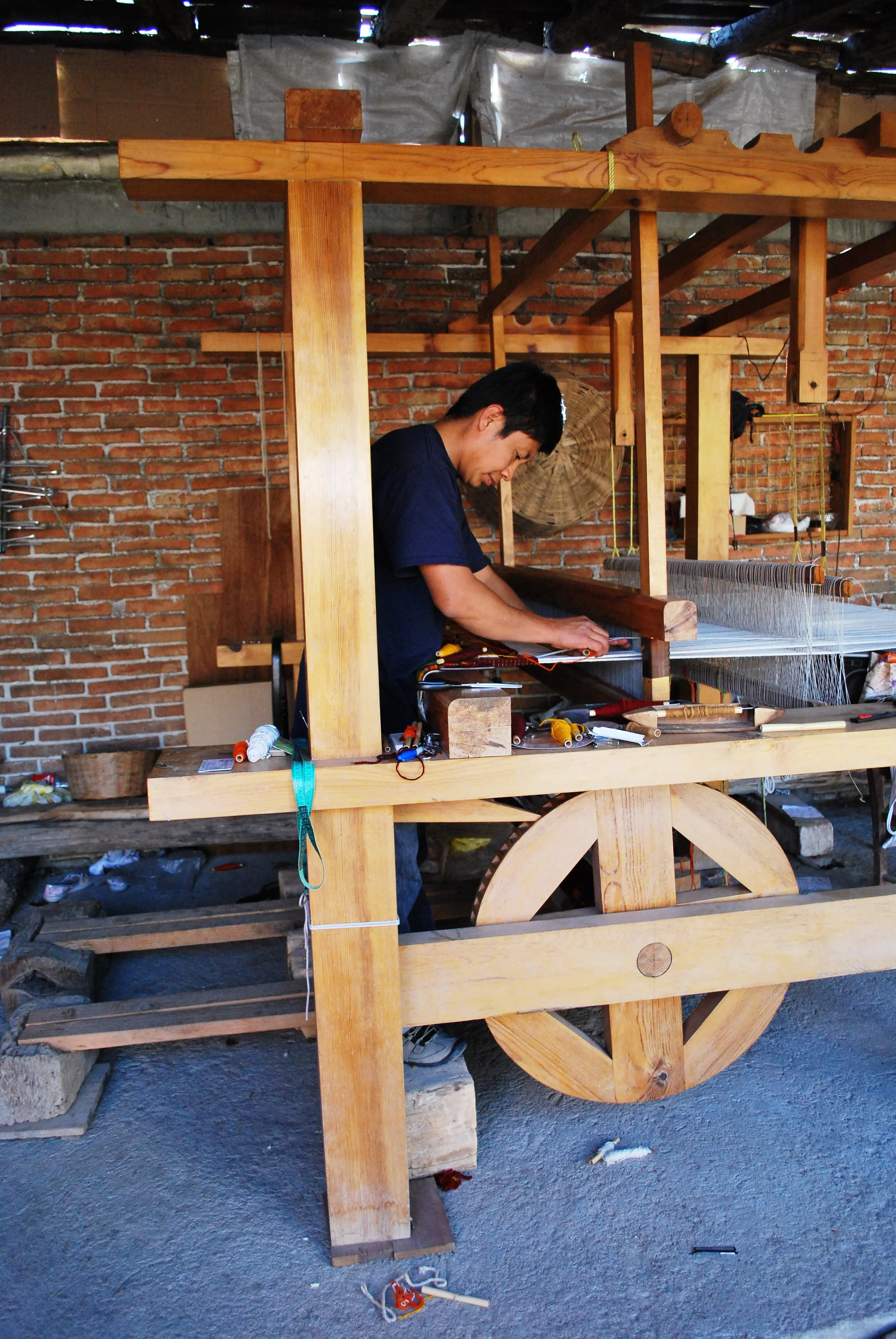 A weaver works at a wooden loom in Teotitlán del Valle, Oaxaca.