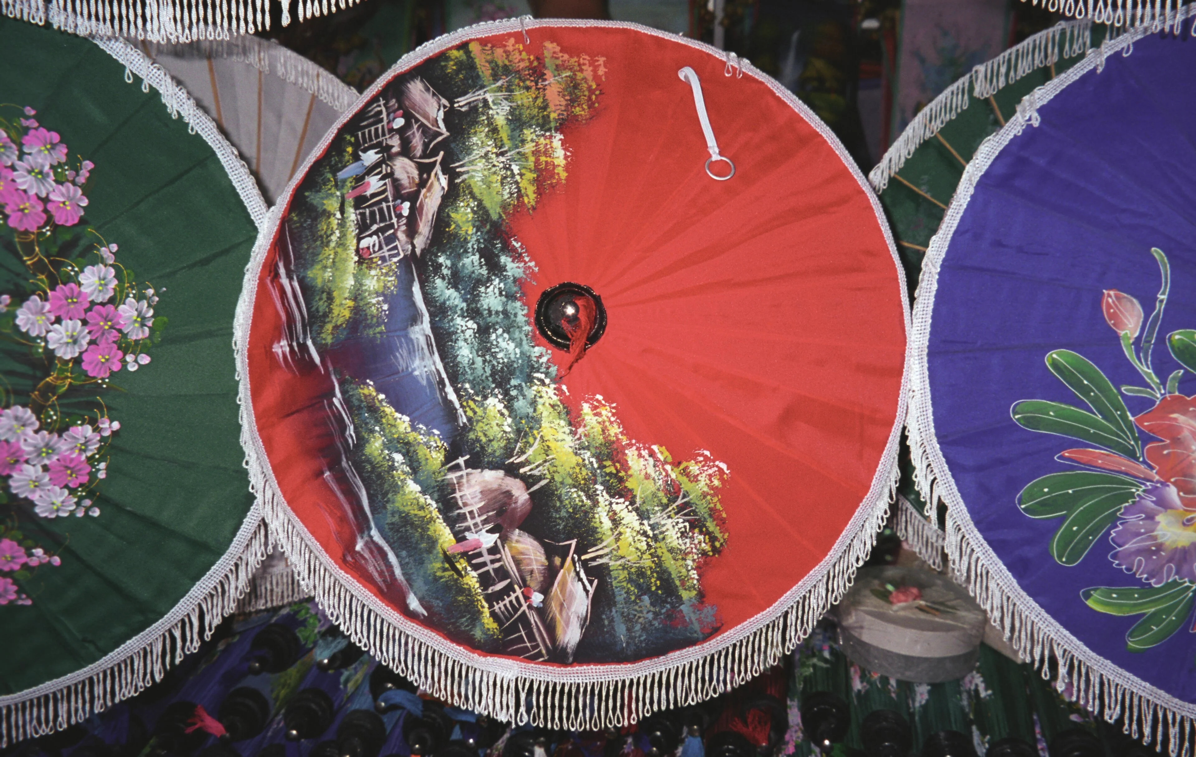 Green, red and blue paper umbrellas overlap at Bo Sang near Chiang Mai.