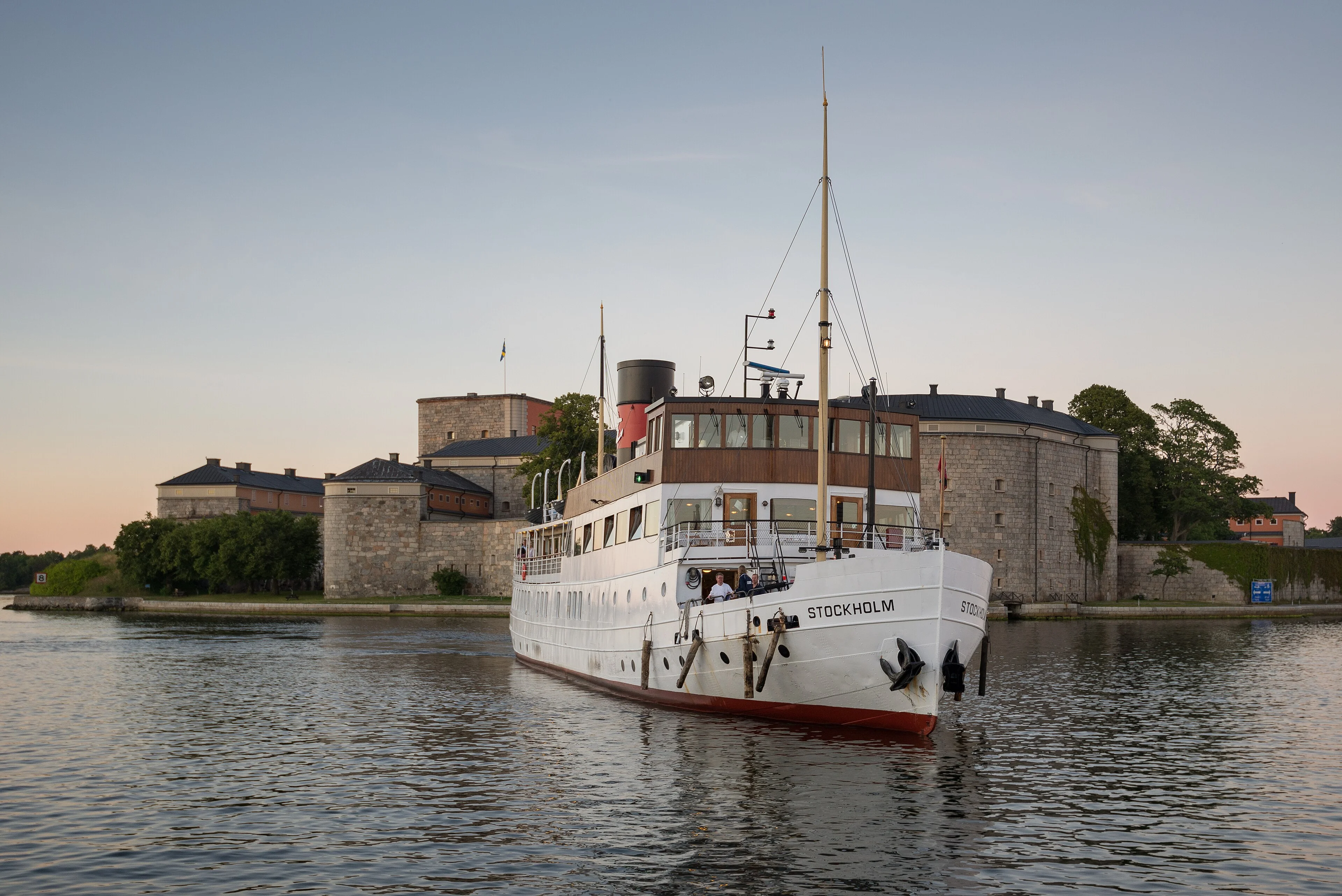 The white passenger ship SS Stockholm travels through calm blue water.